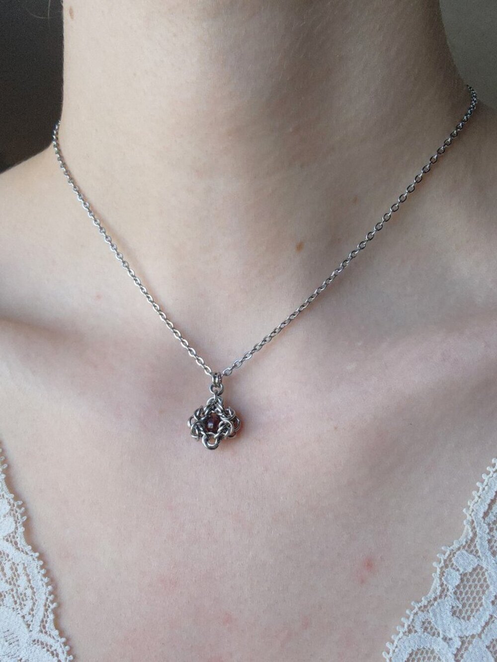 Mini silver necklace with a red garnet